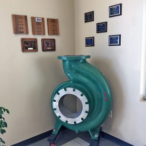 Awards displayed with large pump housing